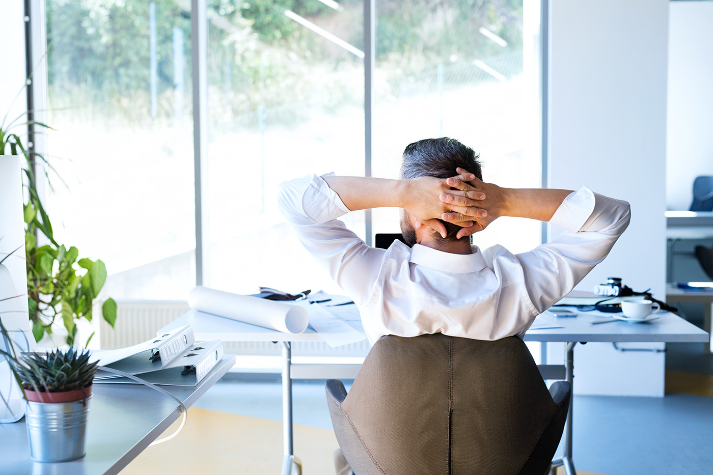 Businessman-at-the-desk-in-his-office-resting.
